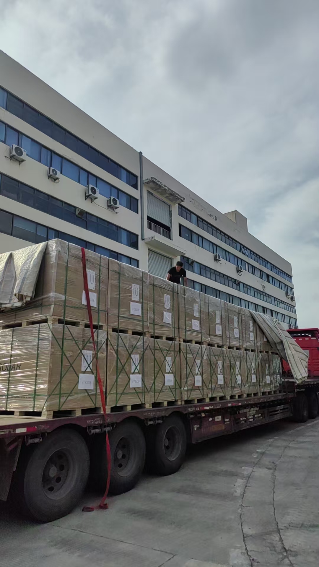 Solar panels being secured on flatbed truck before departure