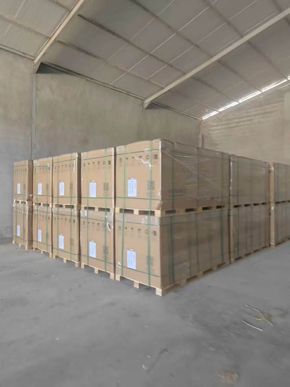 Inverters and BESS units on pallets staged in warehouse ready for export