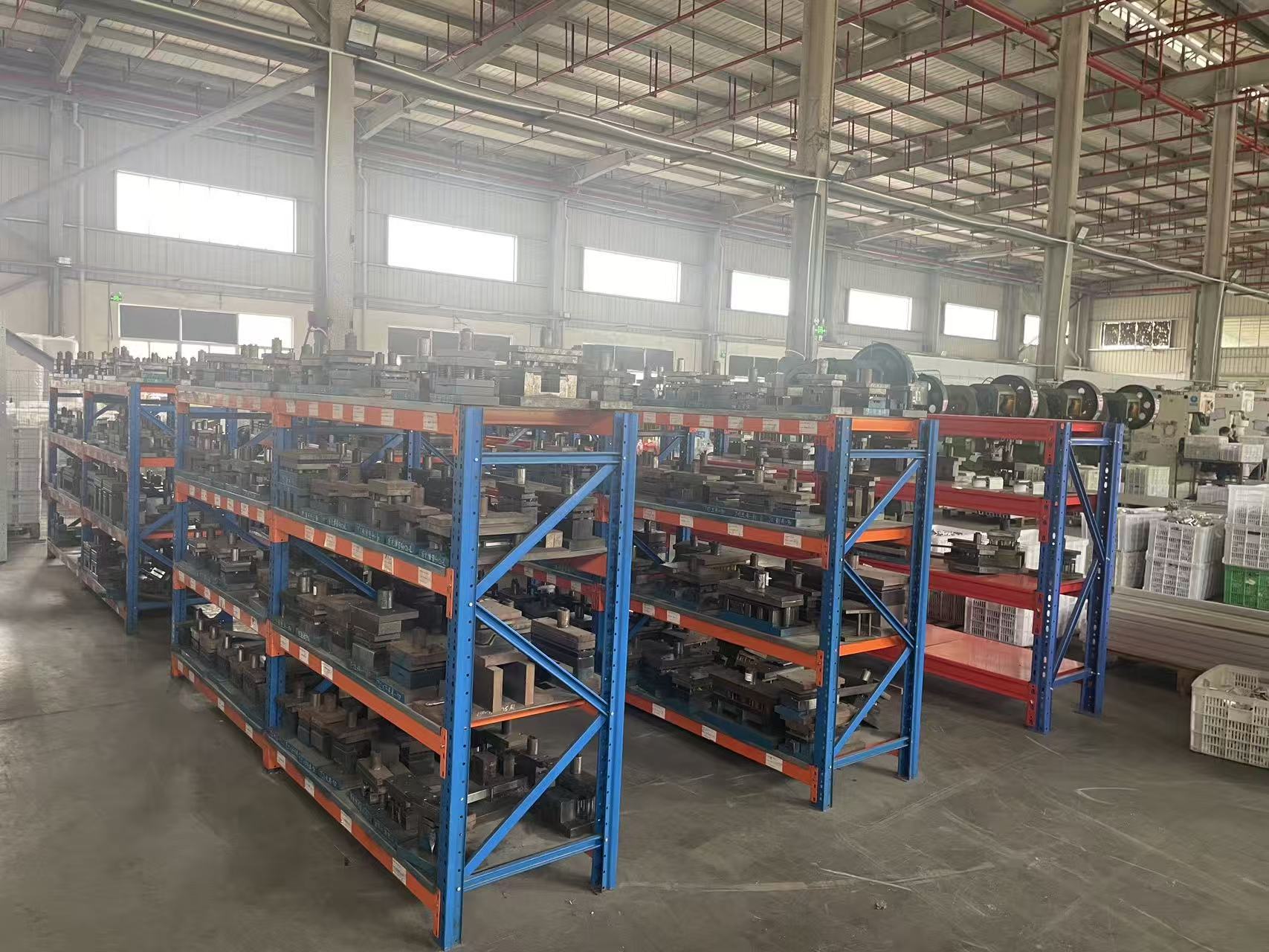 Metal stamping press die storage racks at Econo Solar mounting manufacturing facility