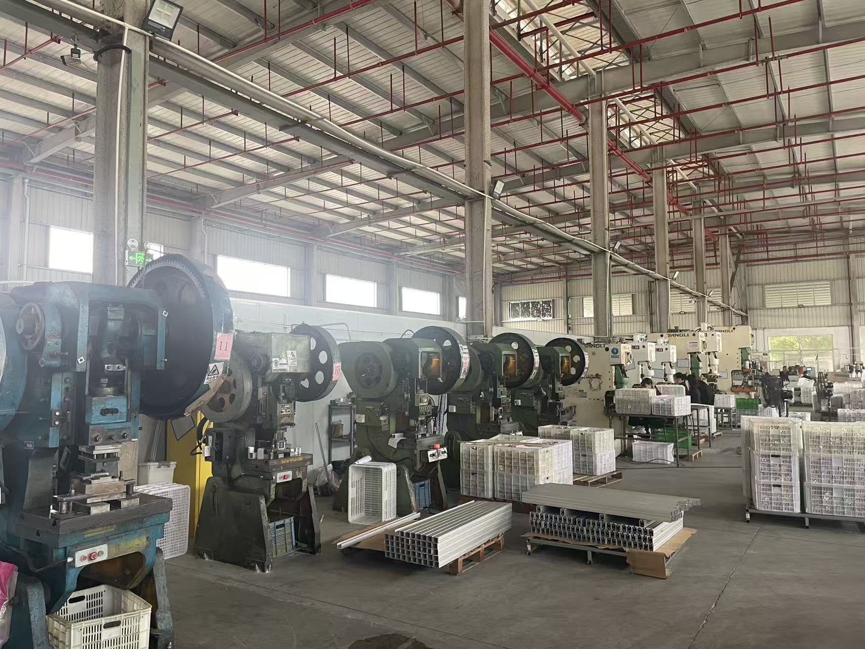 Punch press machines producing aluminum mounting brackets at Econo Solar factory
