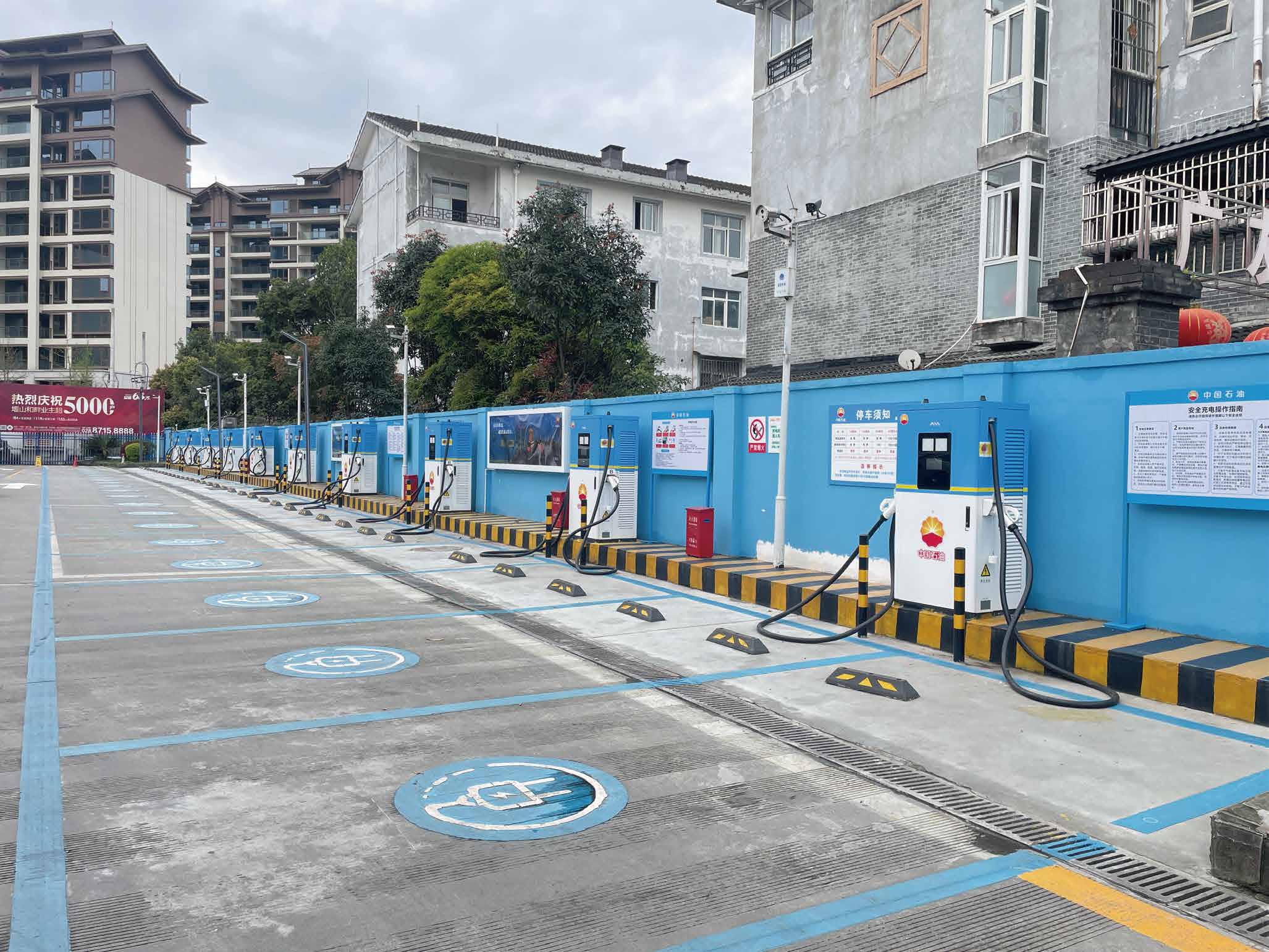 Urban row of EV chargers beside highway